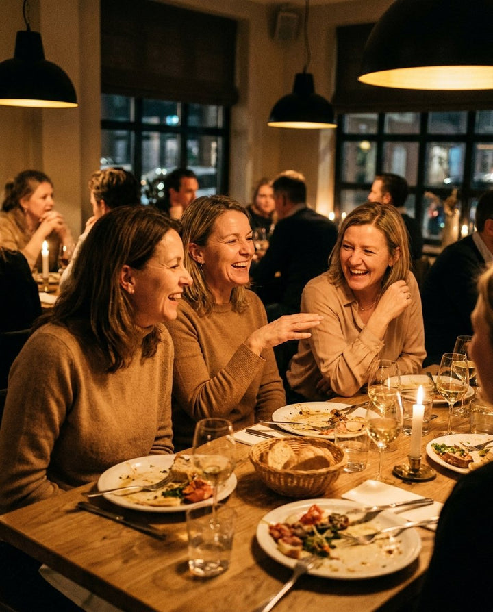 Friends laughing together over dinner